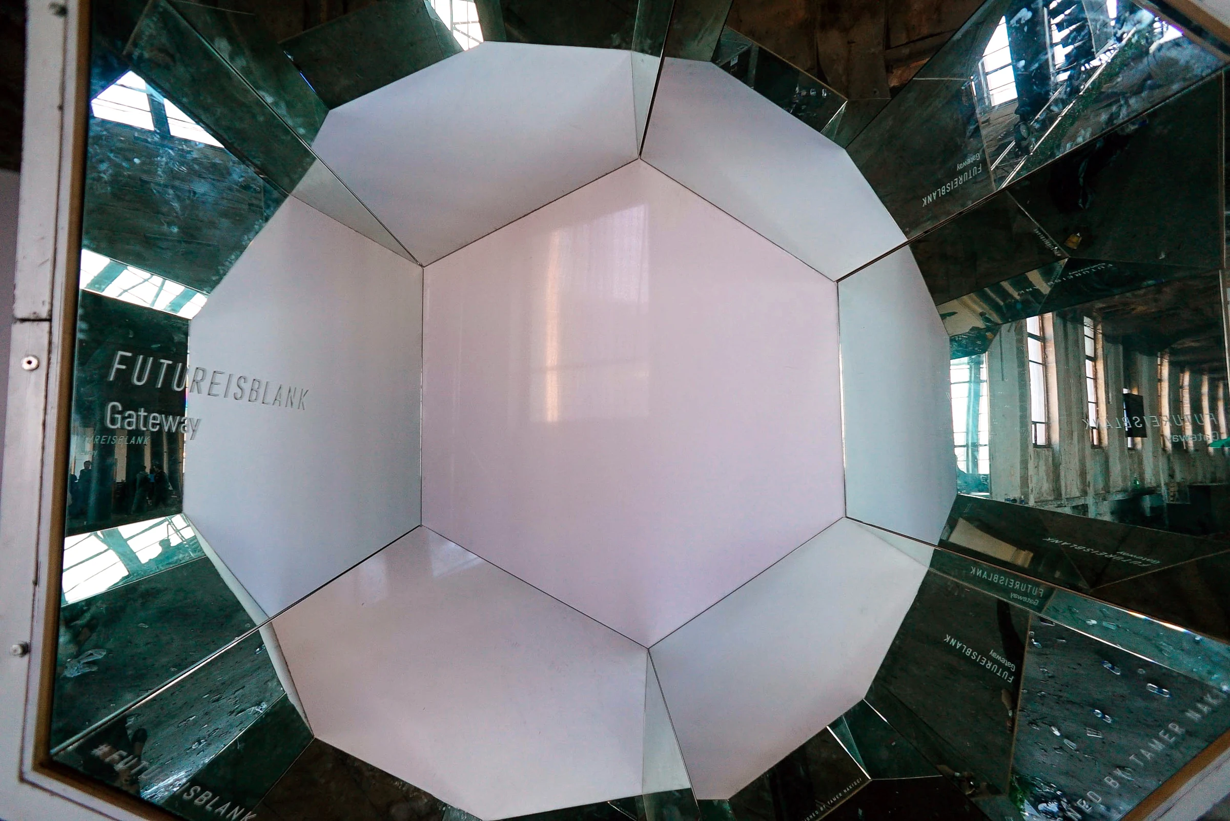 Gateway viewed from the front, with the hall multiplied in its mirrored facets