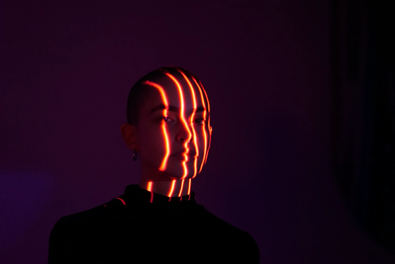 Portrait study with orange light tracing the contours of the face