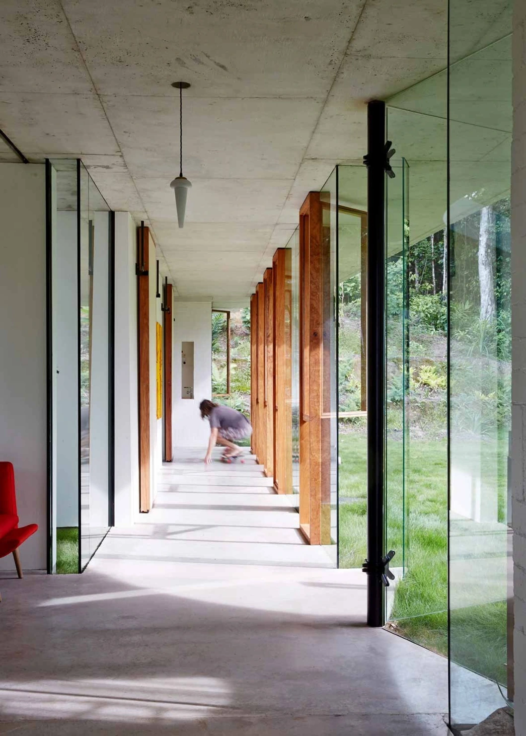 Concrete and glass corridor opening onto the landscape