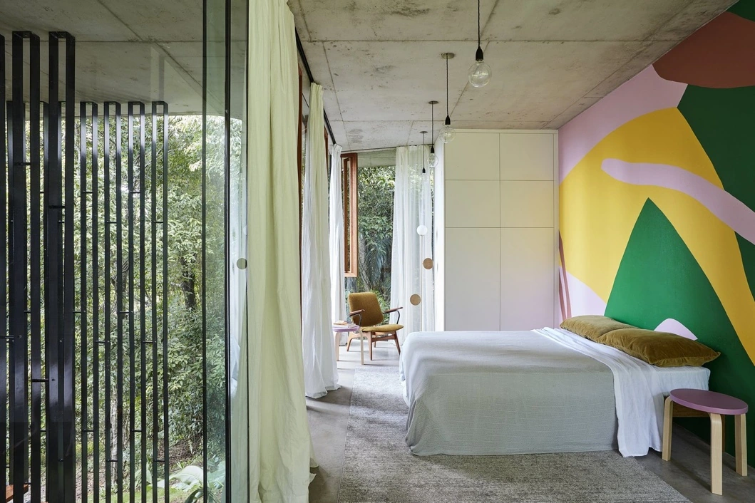 Colourful bedroom with a mural at Planchonella House