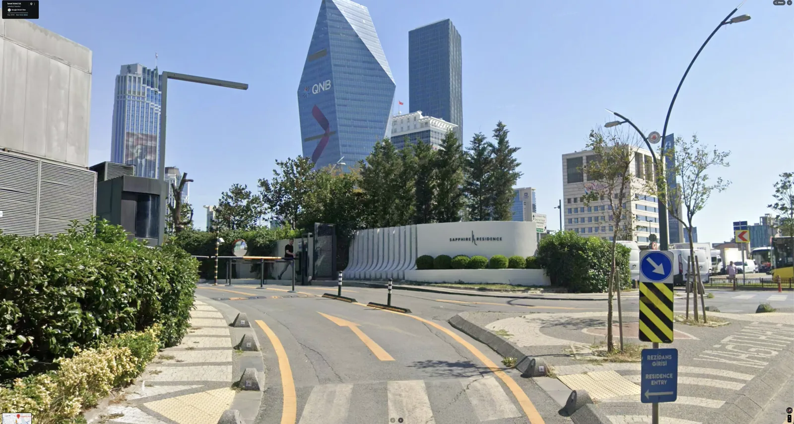 The complete approach, gate and sculptural entrance from the street