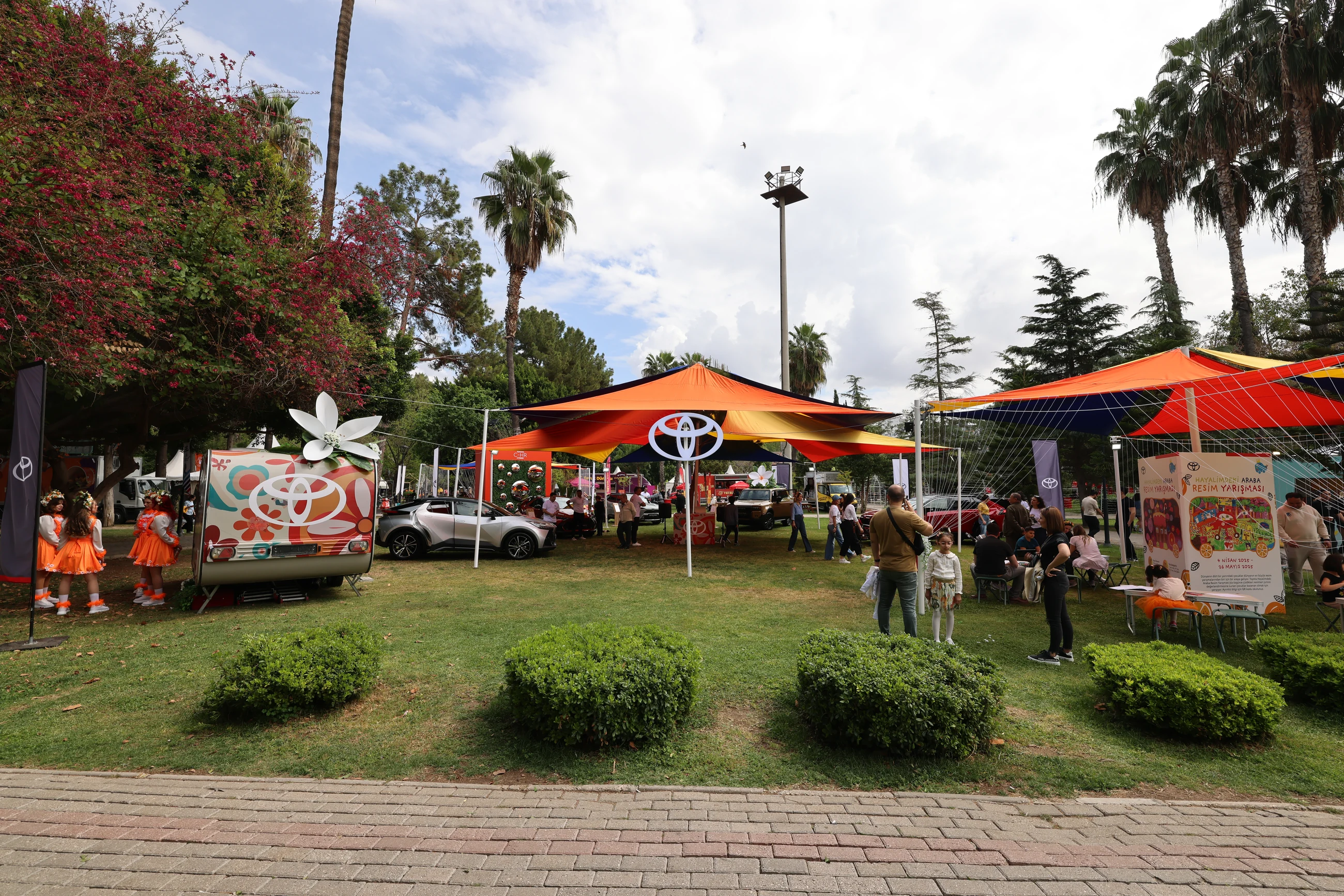 The Toyota cars and interactive installations across the lawn beneath colourful canopies