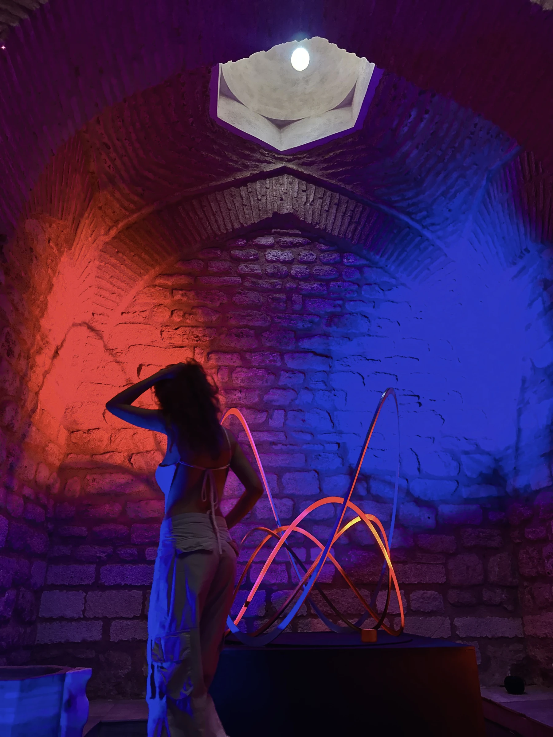 A visitor looking toward Geo Wave beneath the illuminated dome