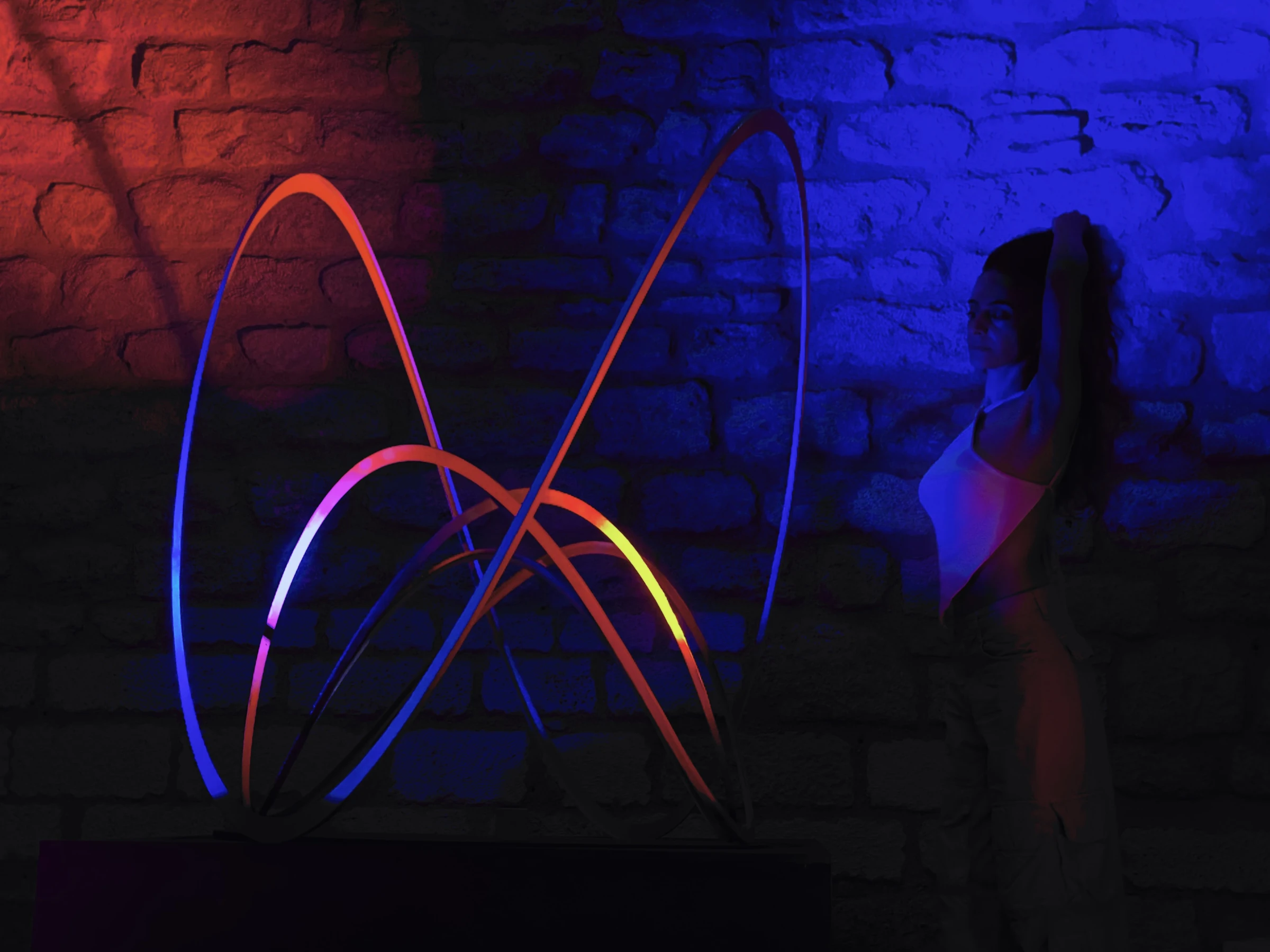 A visitor beside Geo Wave, with the shadows of its curves on the wall